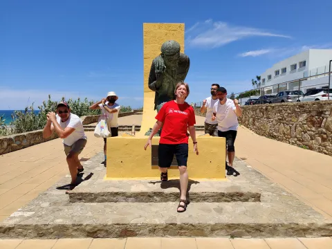 The Adelfa" team posing with the memorial to the fisherman