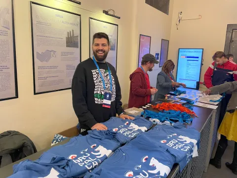 DrupalCamp Berlin organisers hand out merchandising to attendees