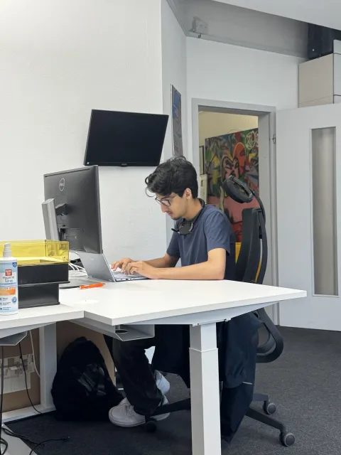 Shamir working at his office desk