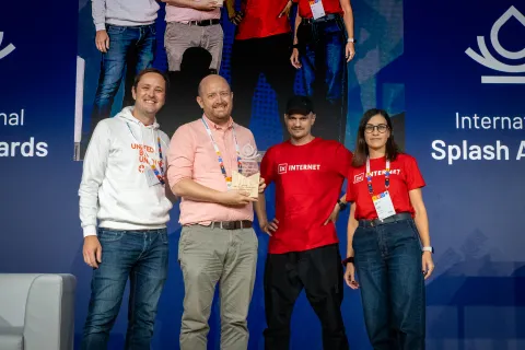 1xTEAM receiving a web award together with a WCD client