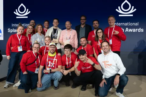 1xTEAM and our clients celebrating web awards on stage