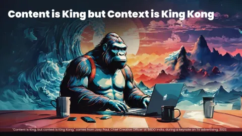 A muscular gorilla seated at a desk, using a laptop in a artistic landscape