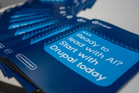 A close-up of a staggered stack of dark blue promotional leaflets