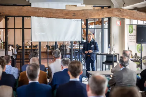 A speaker giving a talk in a modern conference room